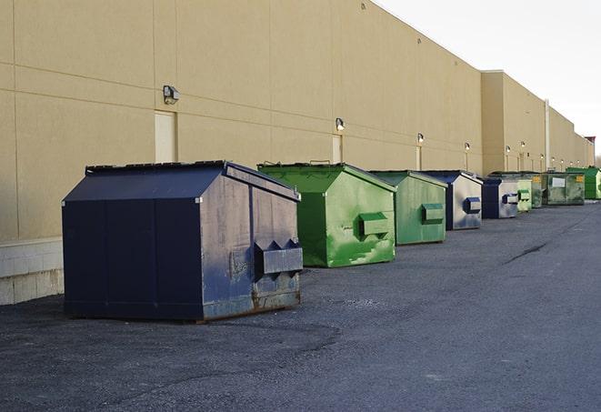 a row of heavy-duty dumpsters ready for use at a construction project in Greenville, FL